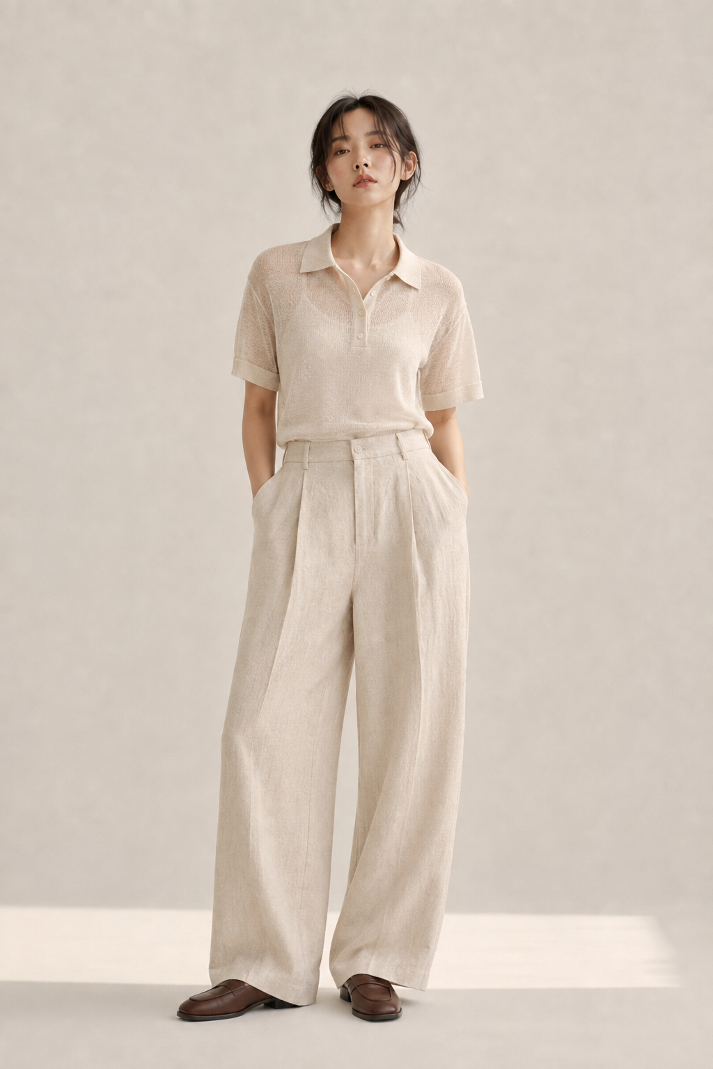 Sheer-knit polo shirt paired with wide-leg linen trousers and leather loafers, light warm-weather acubi tailoring.